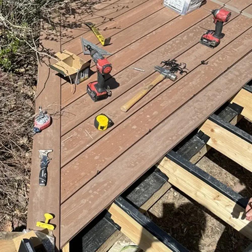 Siding & Deck Repairs in Bozeman - MT underway as a technician secures loose deck boards
